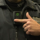 An NYPD officer modeling a body cam in 2014.